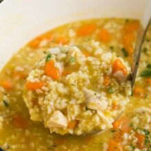 square image of chicken rice soup coming out of pot.