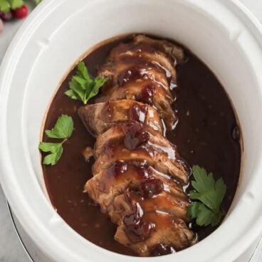 crock pot pork tenderloin with cranberry sauce in slow cooker