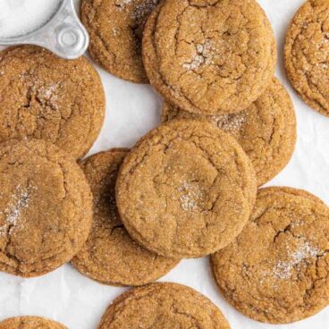 close up image of molasses cookies on a white background.