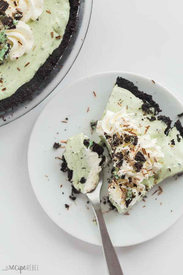grasshopper pie slice on white plate with fork scooping a bite