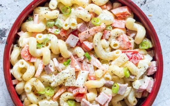 A red bowl full of Hawaiian pasta salad.