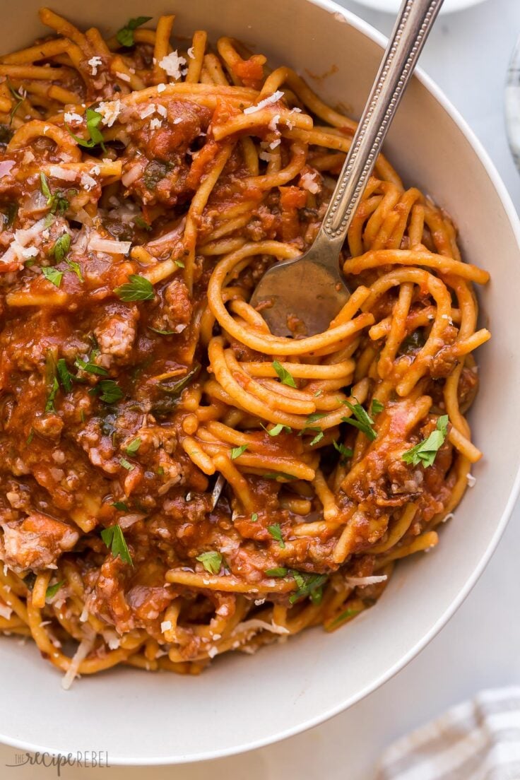 This One Pot Spaghetti and Meat Sauce is a healthy, easy and delicious meal for any night of the week! Made healthier with hidden veggies and whole grain pasta. #pasta #dinner #recipes | one pot spaghetti | one pot pasta | easy dinner ideas | ground beef recipes close up image of one pot spaghetti with fork stuck in