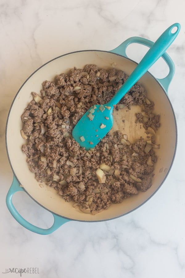 ground beef and onions cooking in pan