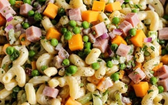 Macaroni salad tossed with ham, cheese, and veggies.