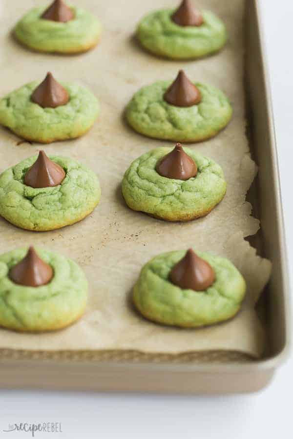 These Mint Hershey Kiss Cookies are the perfect Christmas cookies to add to your holiday baking list! They're so easy to make and fun to eat! #cookie #cookies #baking #recipe #christmas mint hershey kiss cookies on baking sheet lined with parchment paper