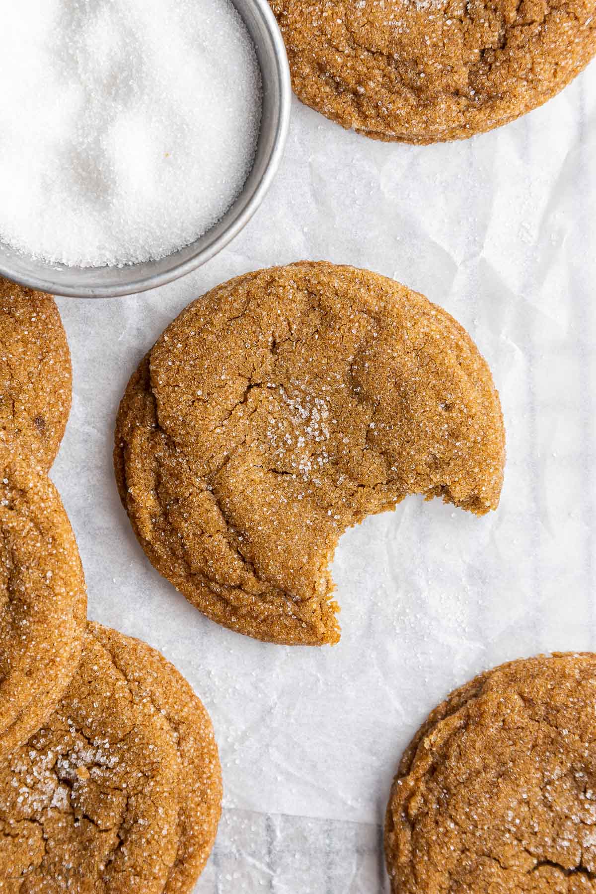 one bite taken out of a molasses cookie.