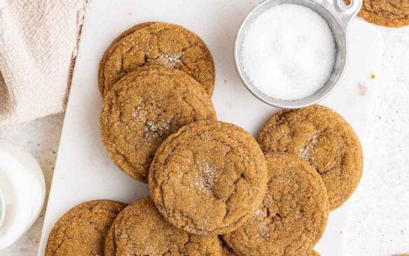 overhead image of molasses cookies with bottles of milk around.