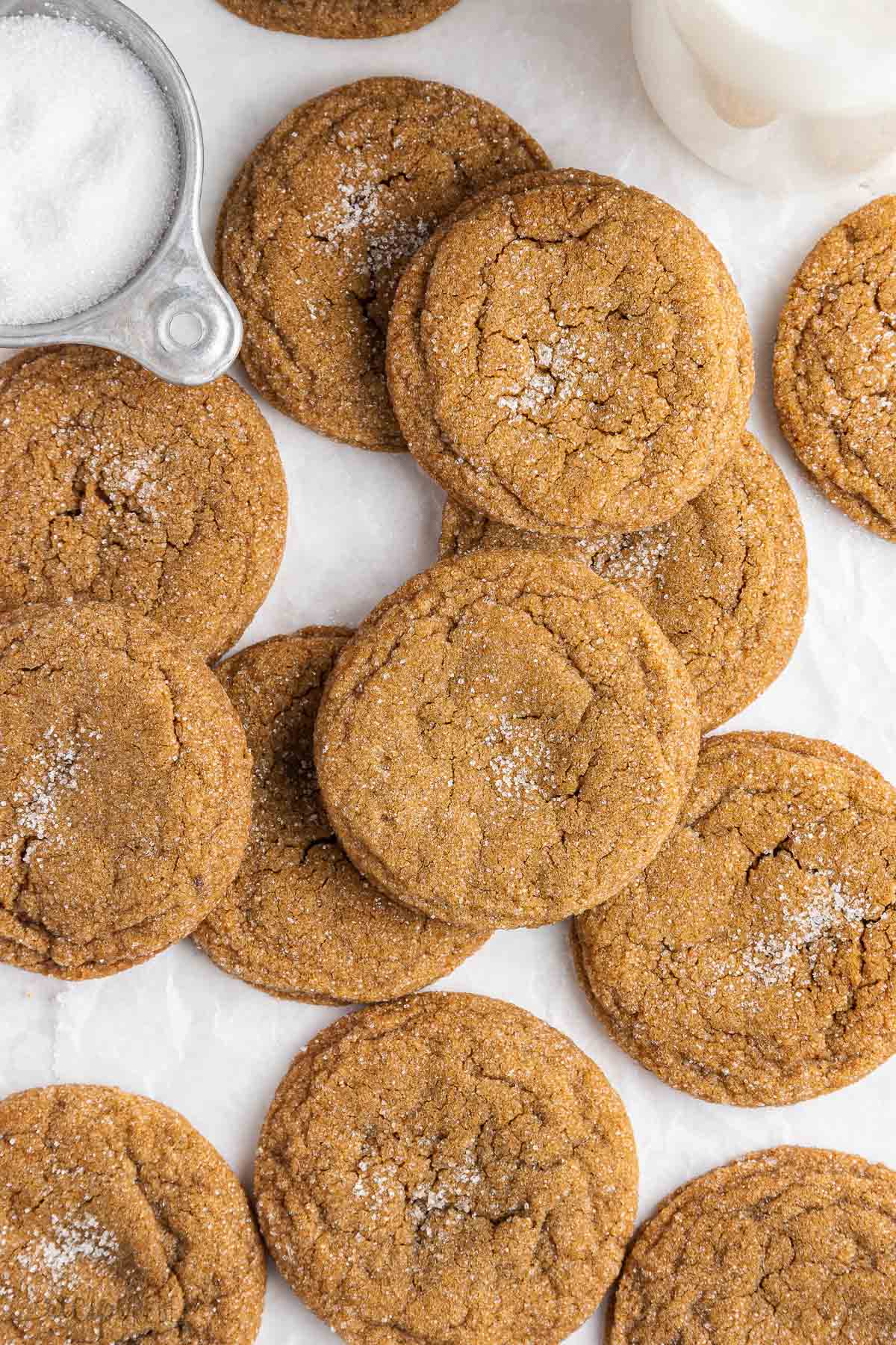 close up image of molasses cookies on a white background.