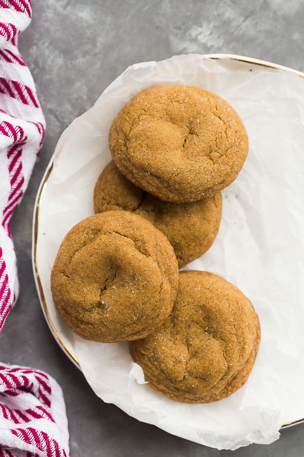 molasses cookies overhead four on white plate lined with parchment paper