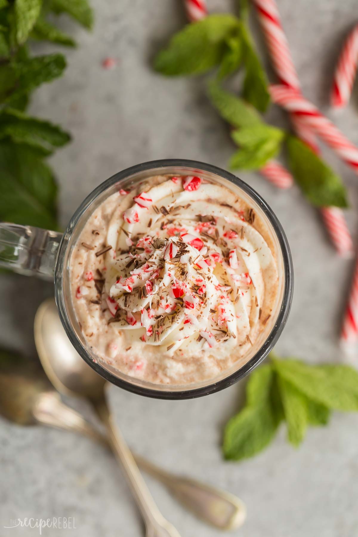 overhead image of peppermint mocha with whipped cream and crushed candy canes.