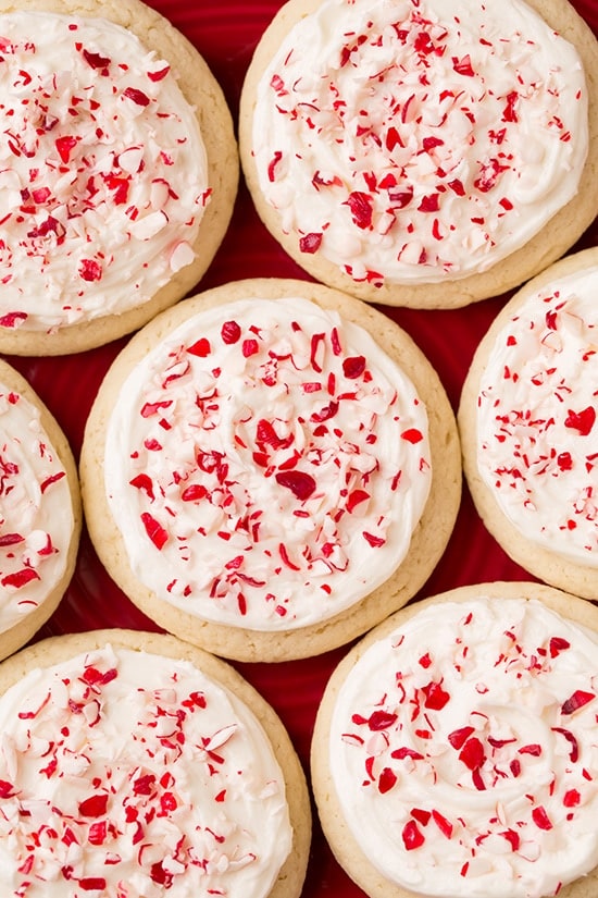 soft frosted peppermint cookies with white frosting and lots of crushed candy canes on top