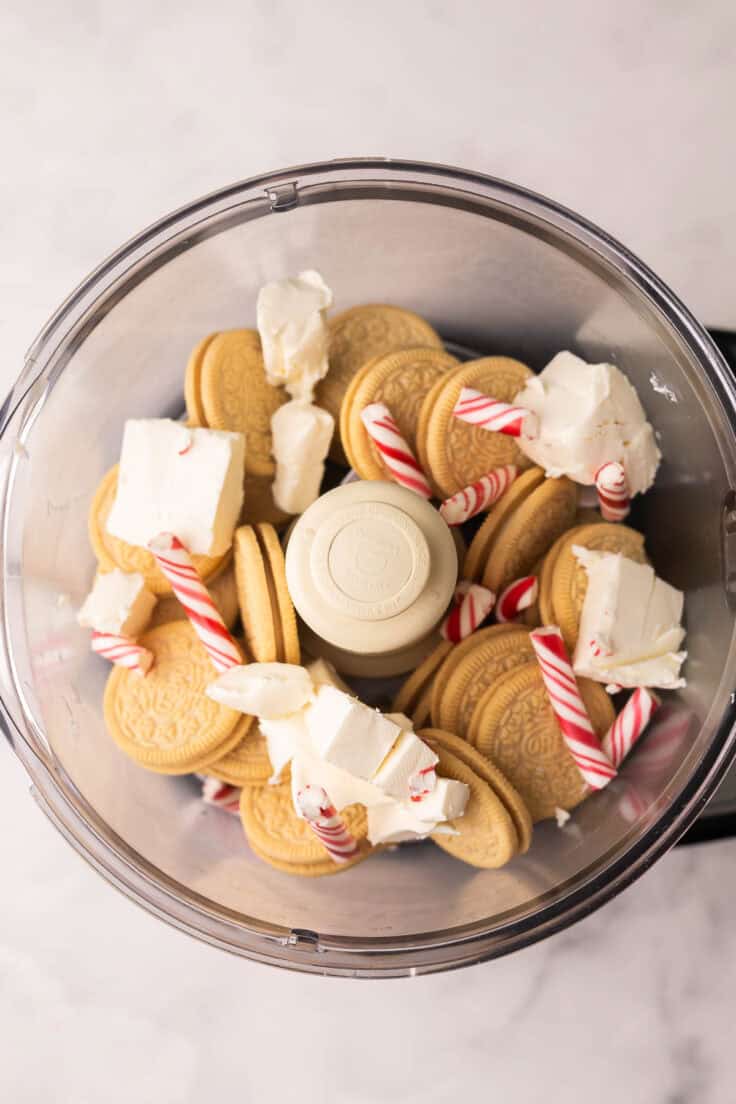 golden oreos candy canes and cream cheese in a food processor.