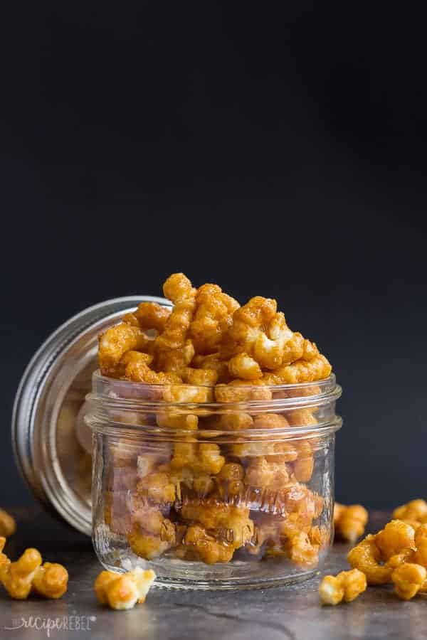 caramel puff corn in glass jar on a black background