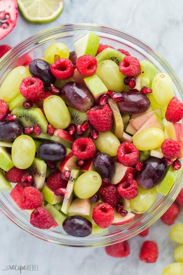 christmas fruit salad overhead red and green on marble background