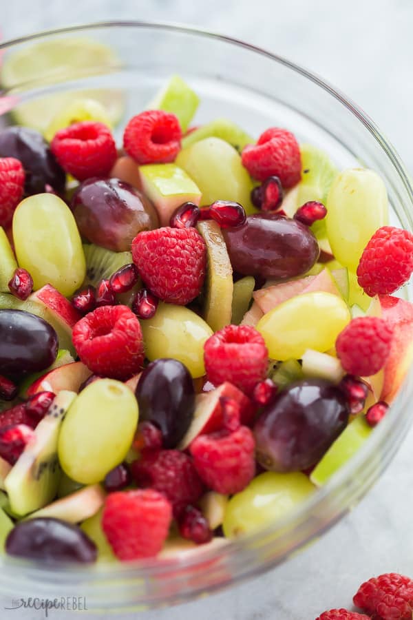 red and green christmas fruit salad close up in clear bowl 