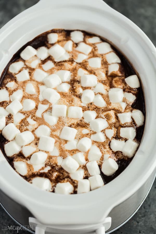 crockpot hot chocolate in slow cooker with lots of mini marshmallows on top