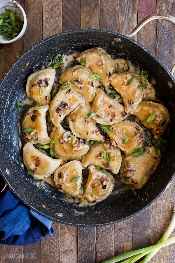 perogies recipe in black pan overhead on dark wooden background