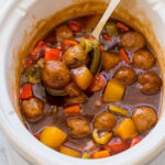 ladle scooping sweet and sour meatballs out of crockpot