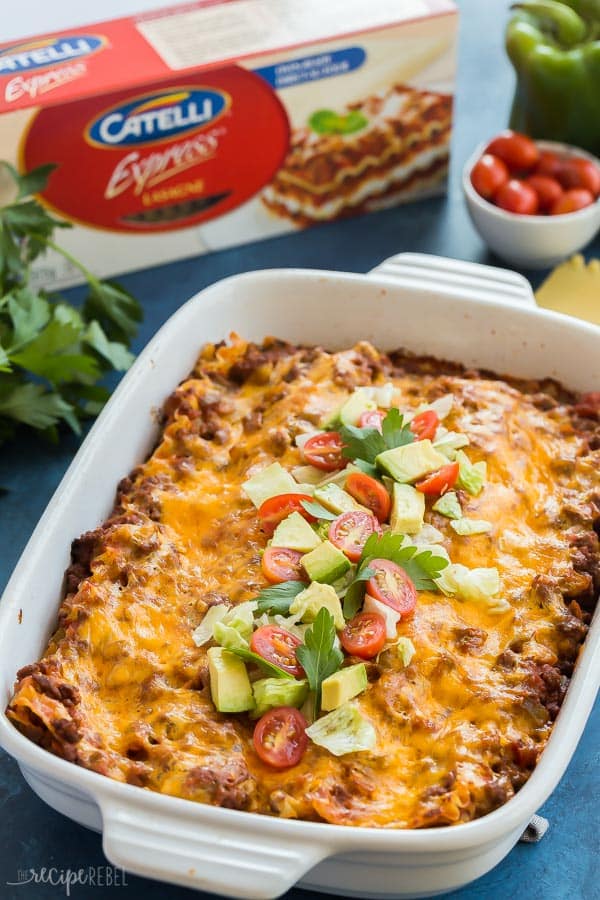 taco lasagna recipe in white pan with noodles