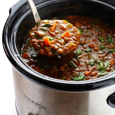 ladle scooping lentil soup out of slow cooker