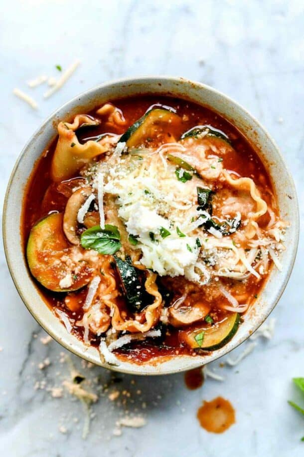 lasagna crockpot soup overhead on marble background with lots of cheese on top