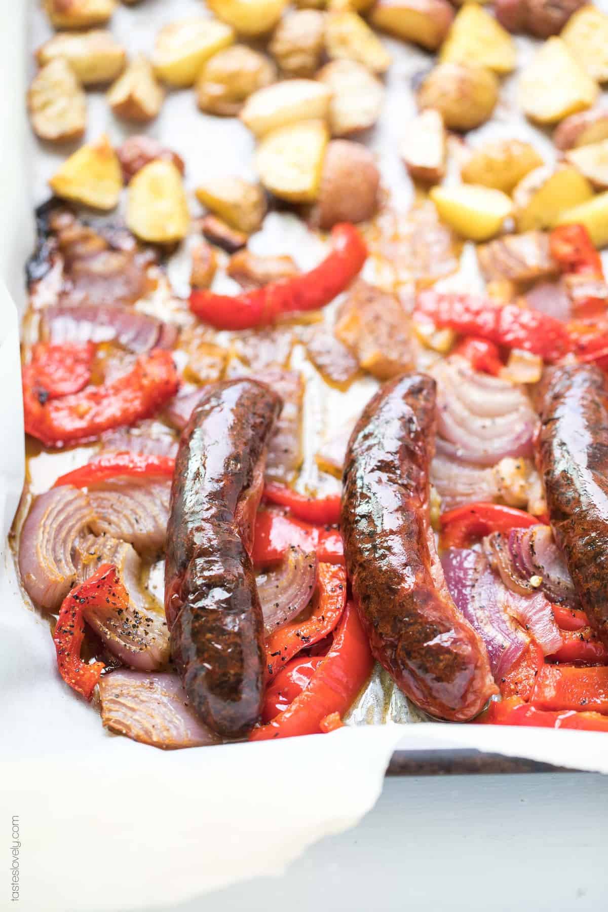 sheet pan sausage and peppers with red onions and potatoes