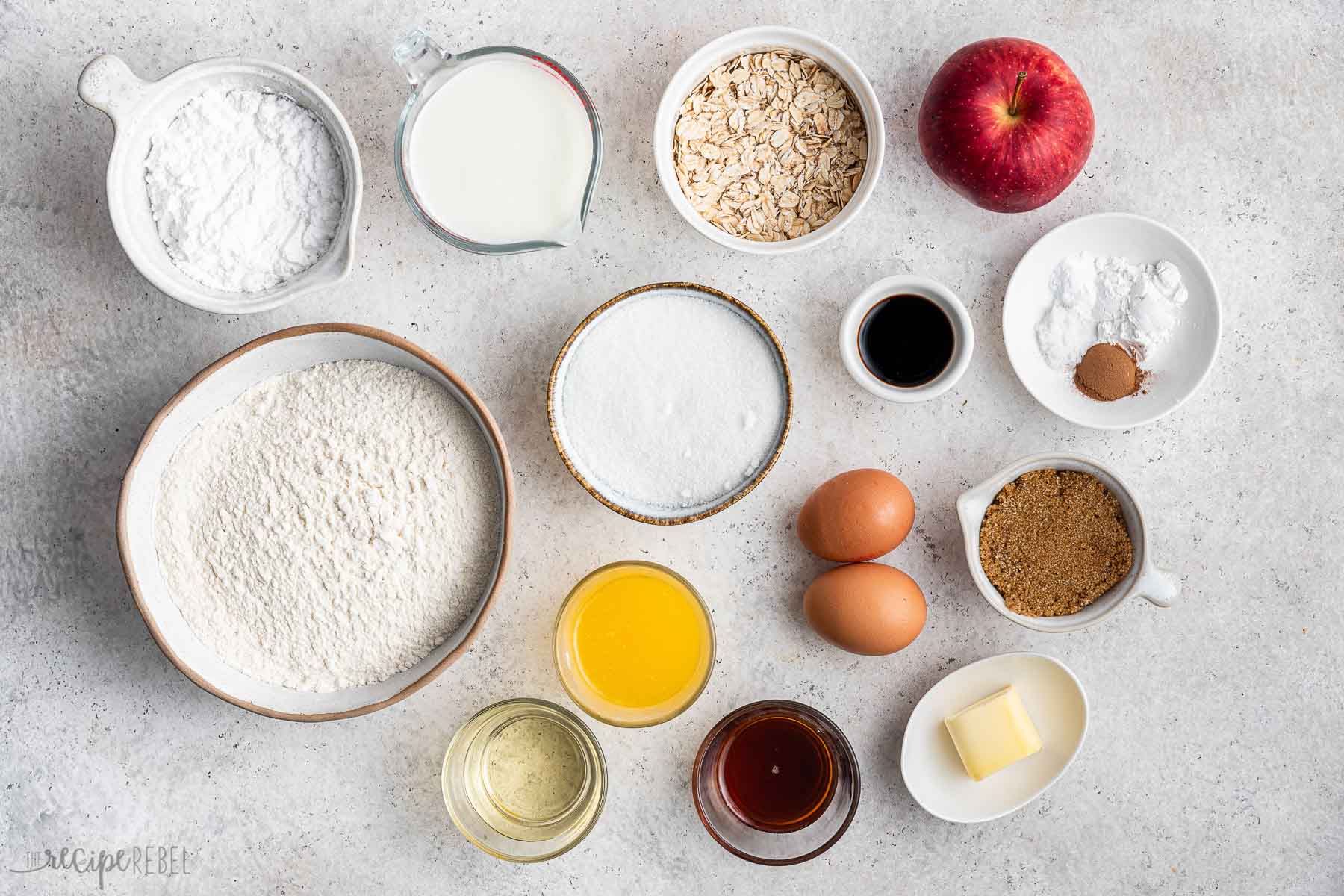 ingredients needed to make apple crisp donuts on grey background.