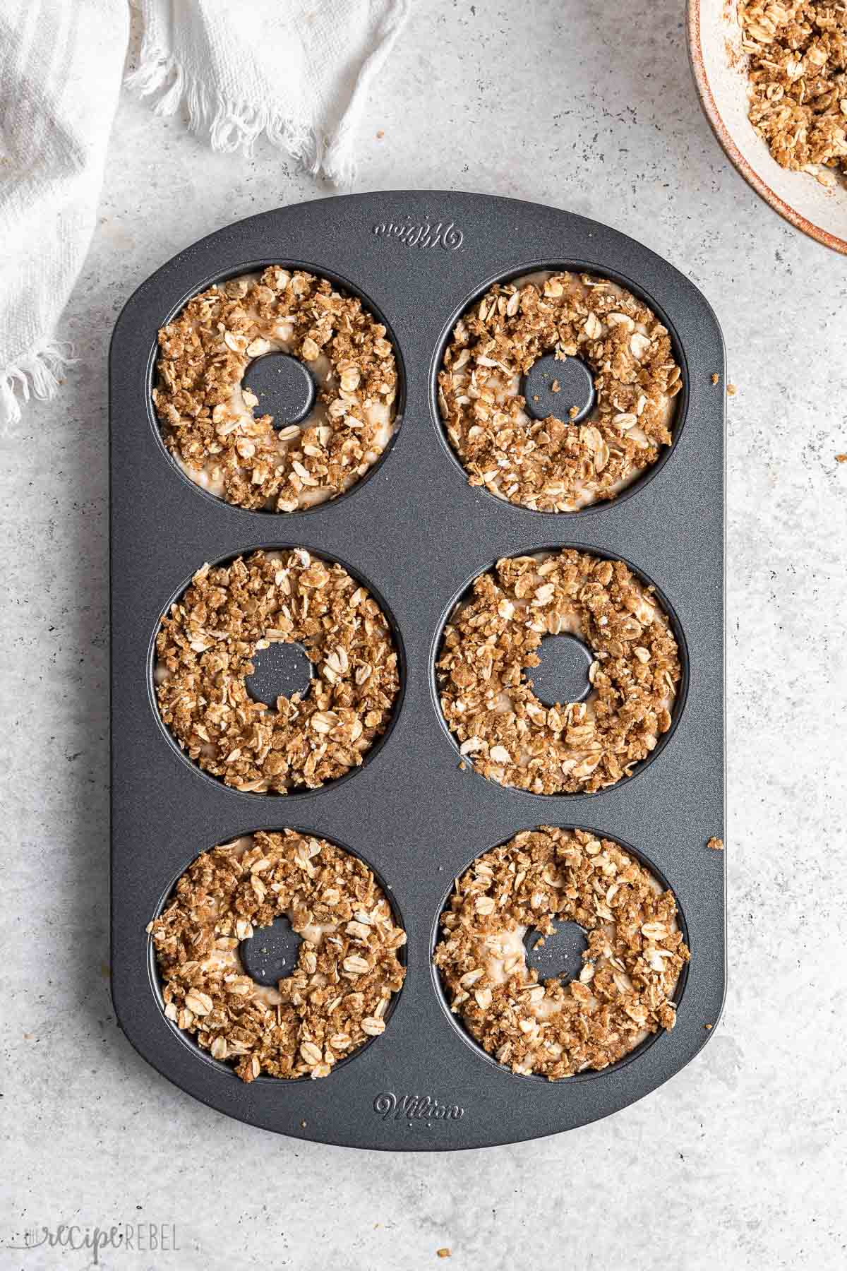 apple crisp donuts in pan ready for the oven.