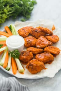 boneless chicken wings with buffalo sauce on white plate