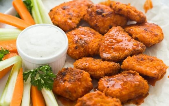 boneless chicken wings with buffalo sauce on white plate