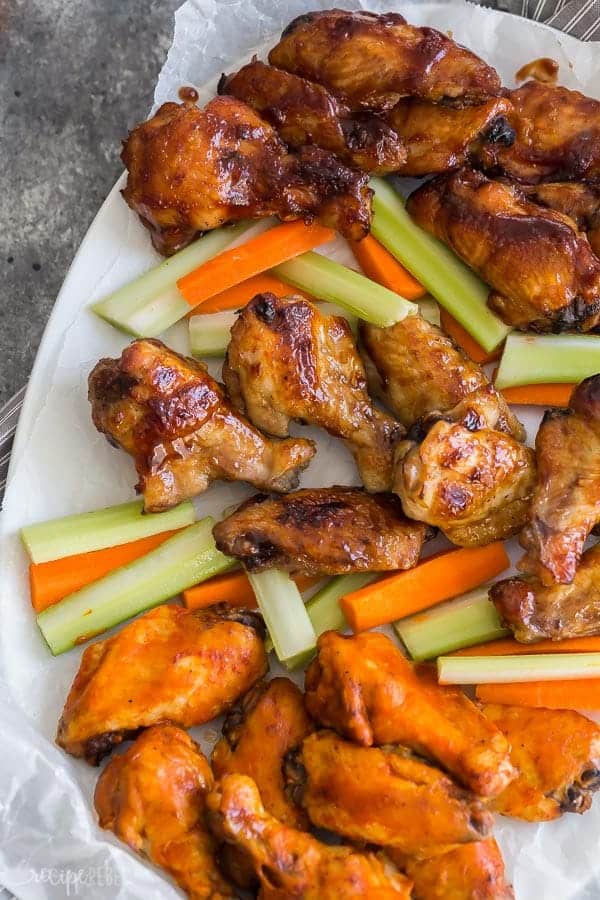 crockpot chicken wings 3 ways on platter with carrots and celery sticks in between