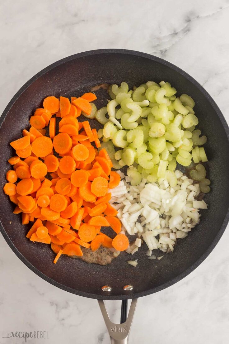 carrots onions and celery in black skillet