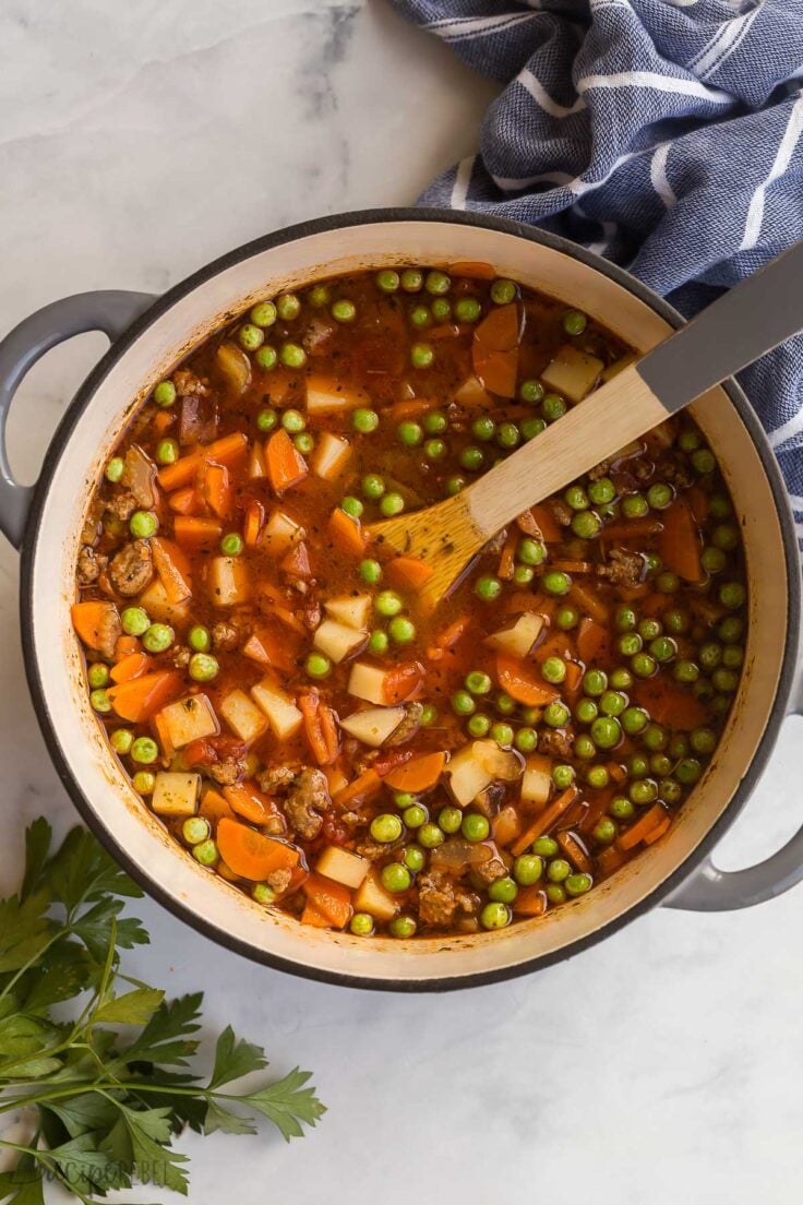 overhead image of hamburger soup with wooden spoon stuck in