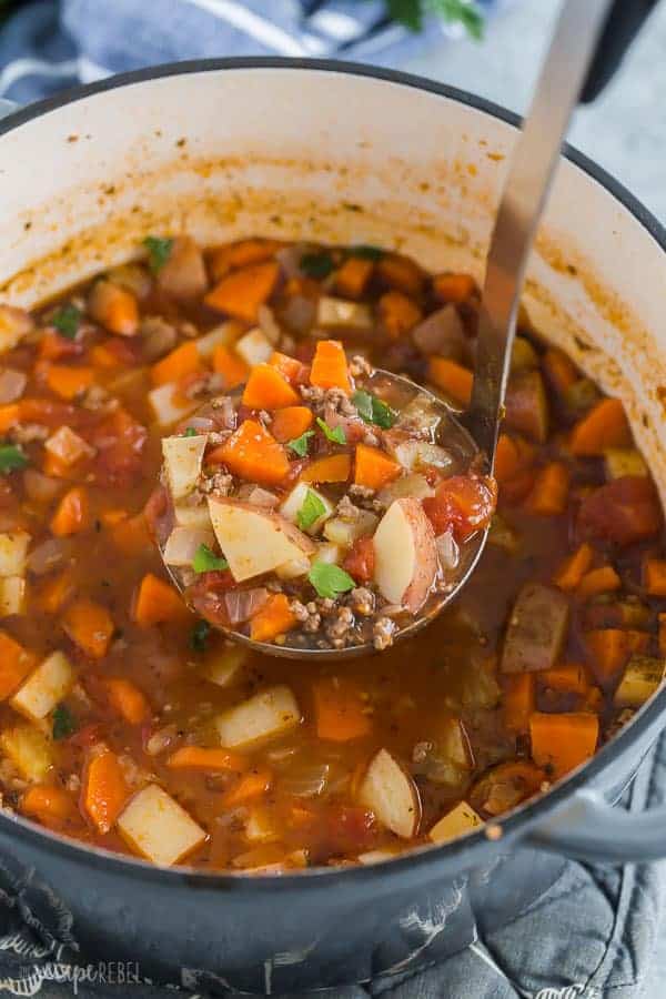 hamburger soup in pot with metal scoop scooping some up