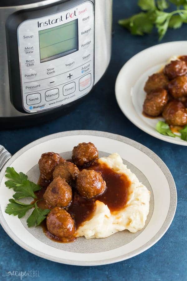 instant pot meatballs with honey garlic sauce on grey plate on blue background in front of an instant pot