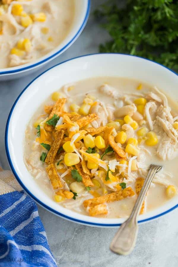 instant pot white chicken chili close up with spoon stuck in the bowl