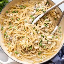 overhead image of one pot turkey tetrazzini in pan with tongs.