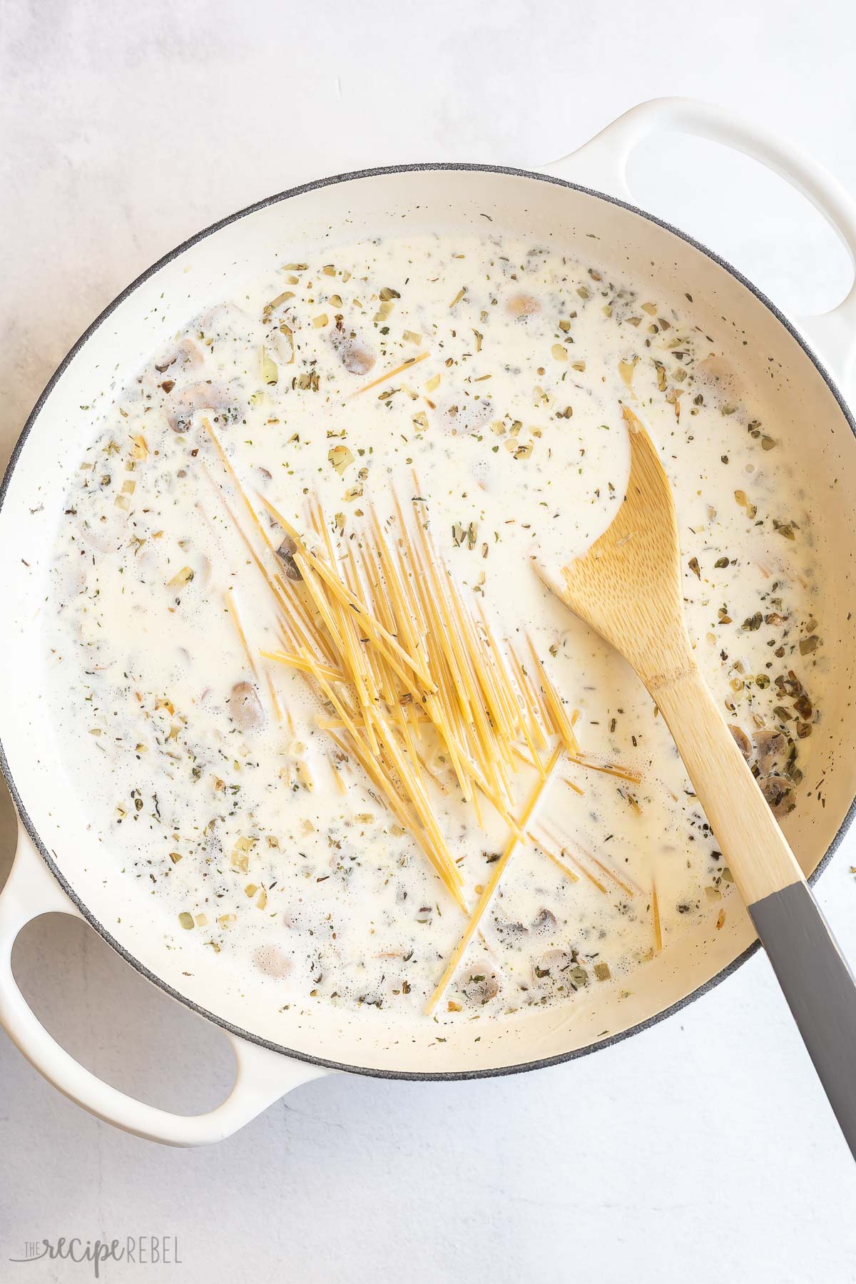 cream and uncooked pasta added to pan with mushrooms.