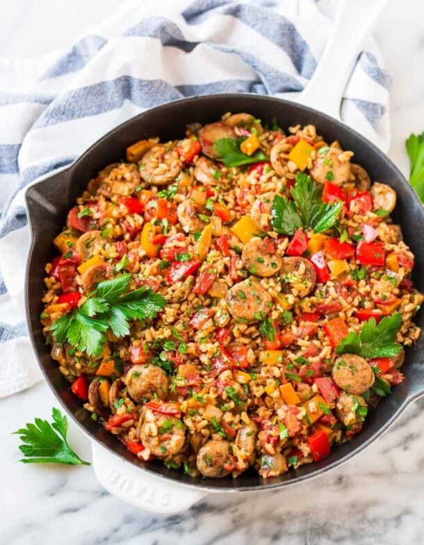 italian sausage rice casserole in cast iron skillet overhead on white and blue towel