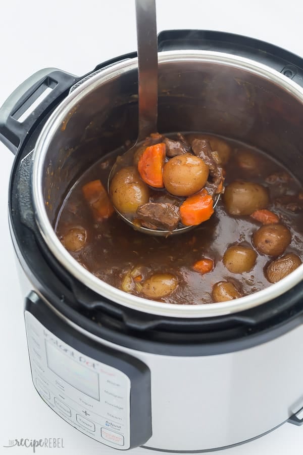 instant pot beef stew in pressure cooker with metal scoop pulling some up