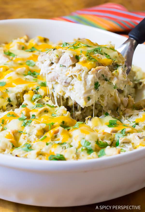 king ranch casserole in white baking dish with scoop being lifted out