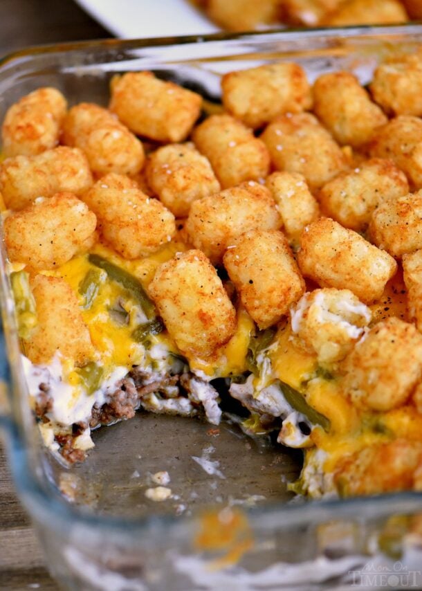 the best tater tot casserole in glass baking dish with a scoop missing