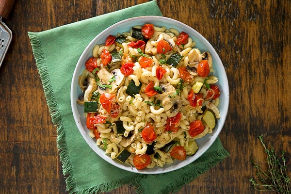 one pot mushroom and zucchini pasta on wooden background