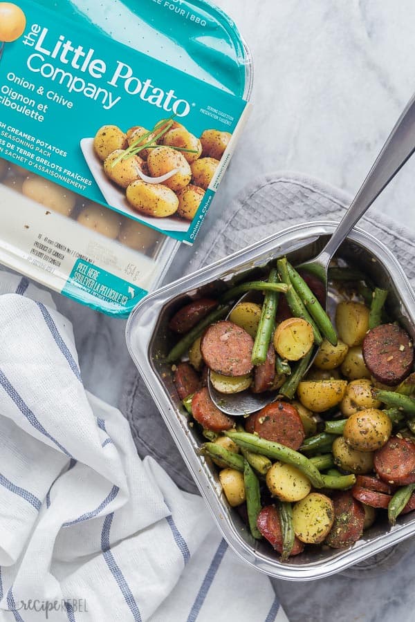 sausage potatoes and green beans with Little Potatoes package beside on grey marble background