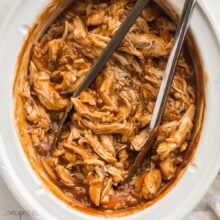 square image of crockpot bbq chicken with tongs