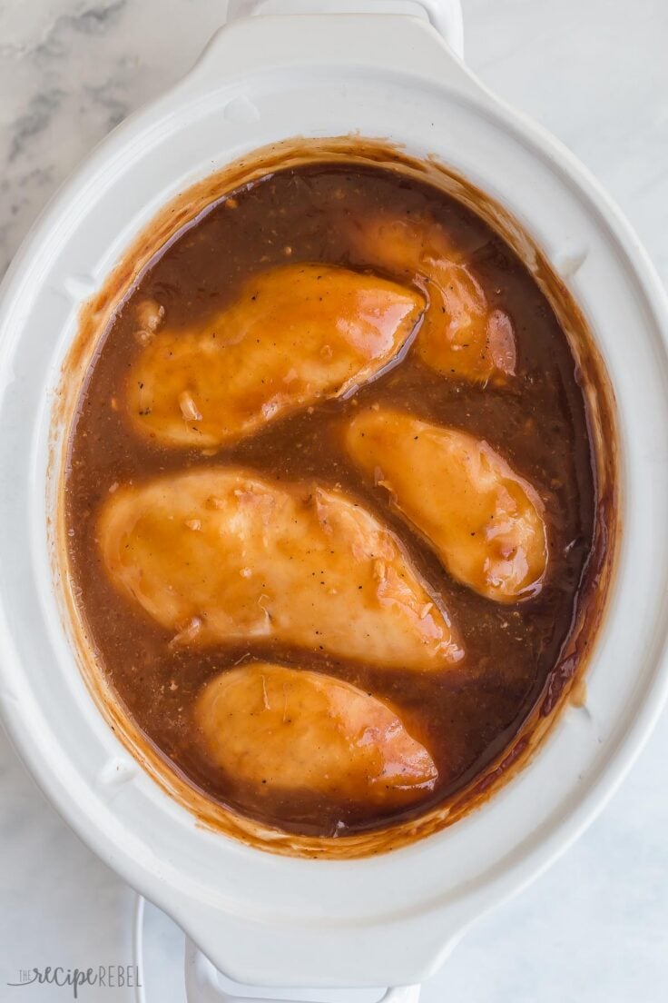 cooked chicken breasts in bbq sauce in crockpot