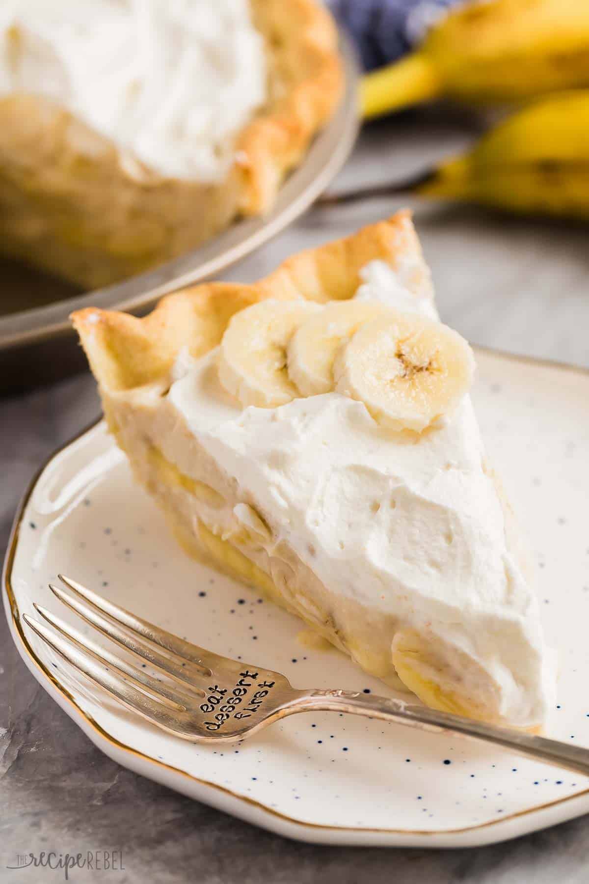 slice of banana cream pie on white speckled plate with fork on plate