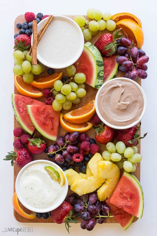 cream cheese fruit dip flavors on fruit platter on wooden board with white background