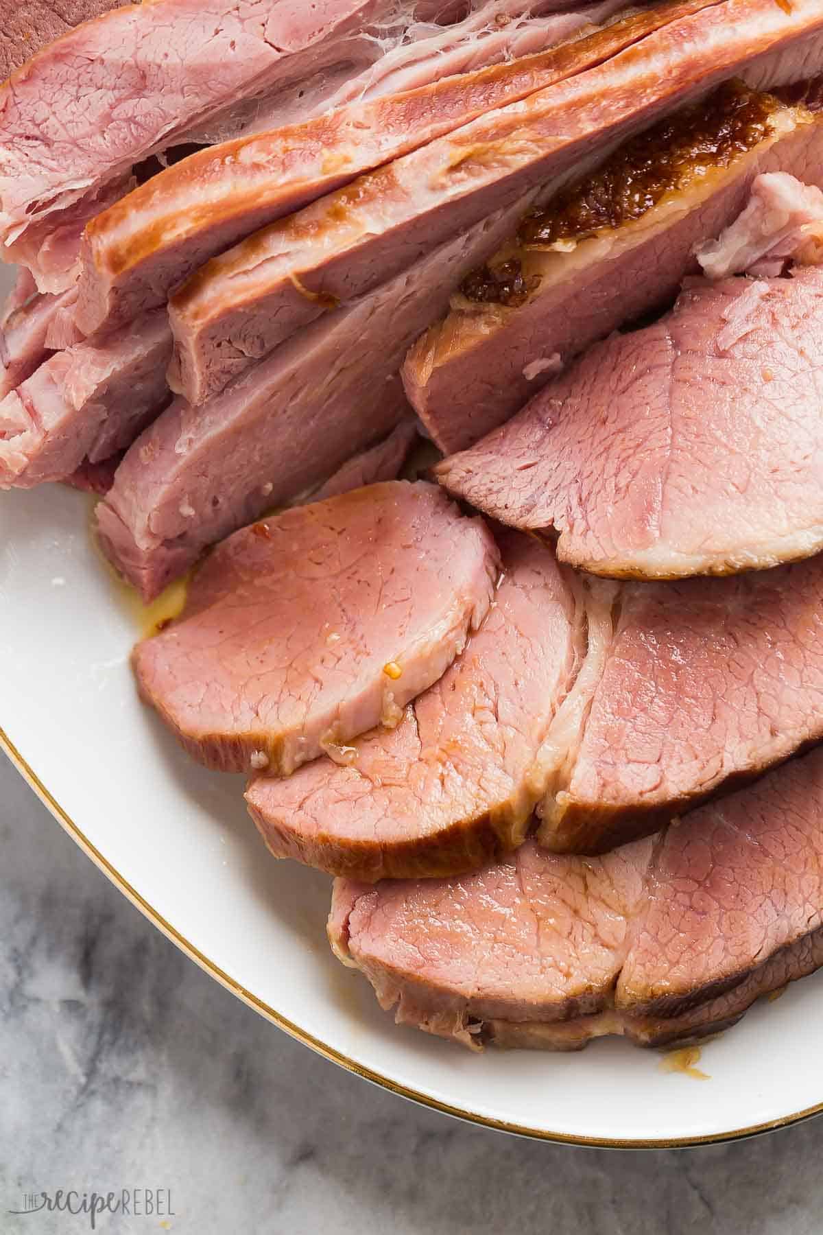instant pot ham close up on white platter with pineapple glaze