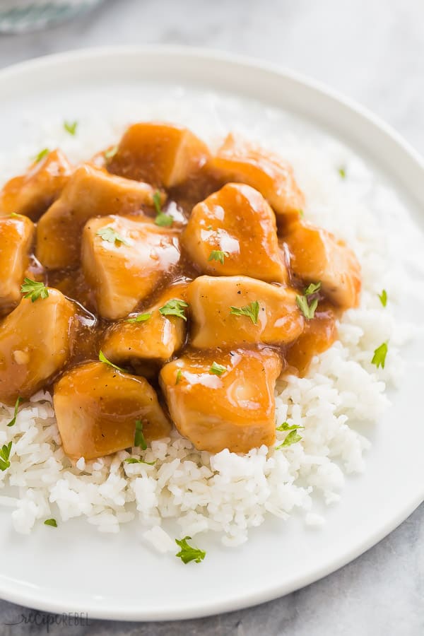 instant pot chicken with honey garlic sauce on white rice on a white plate